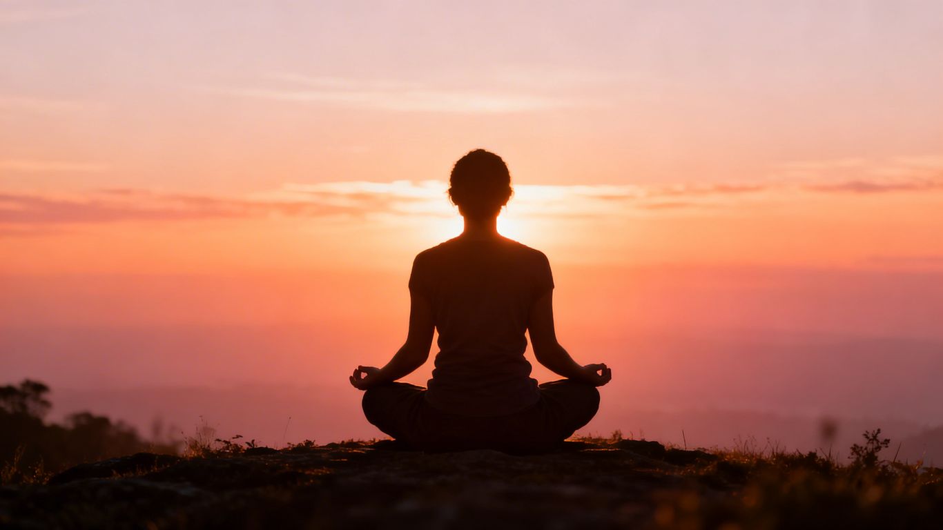 Sunrise with person meditating for morning affirmations.